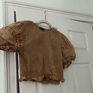 A large strut and bolt top with detailed puff sleeves. A little cropped.